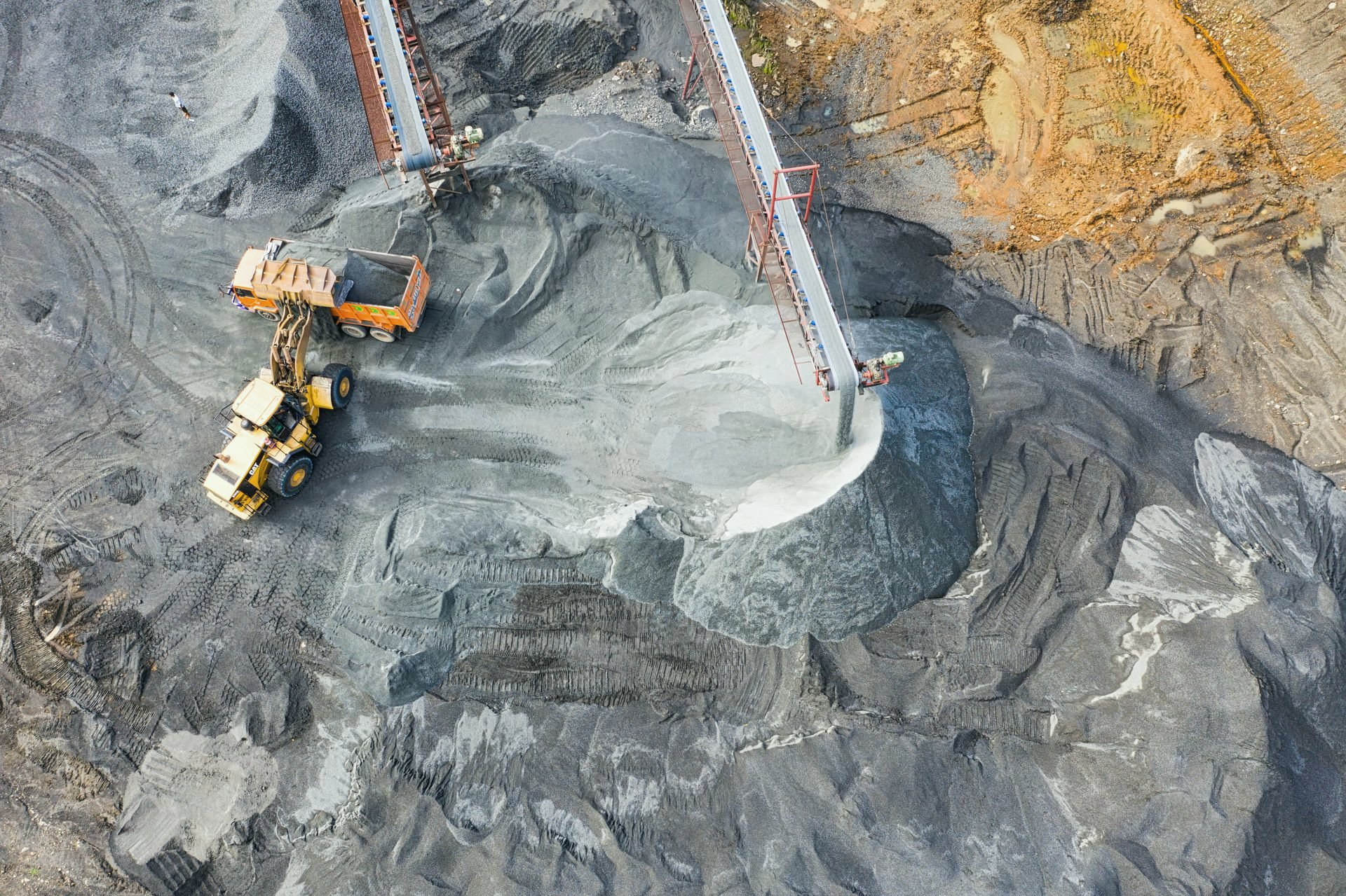 Haul trucks and heavy equipment at an open-pit mine in cold northern conditions