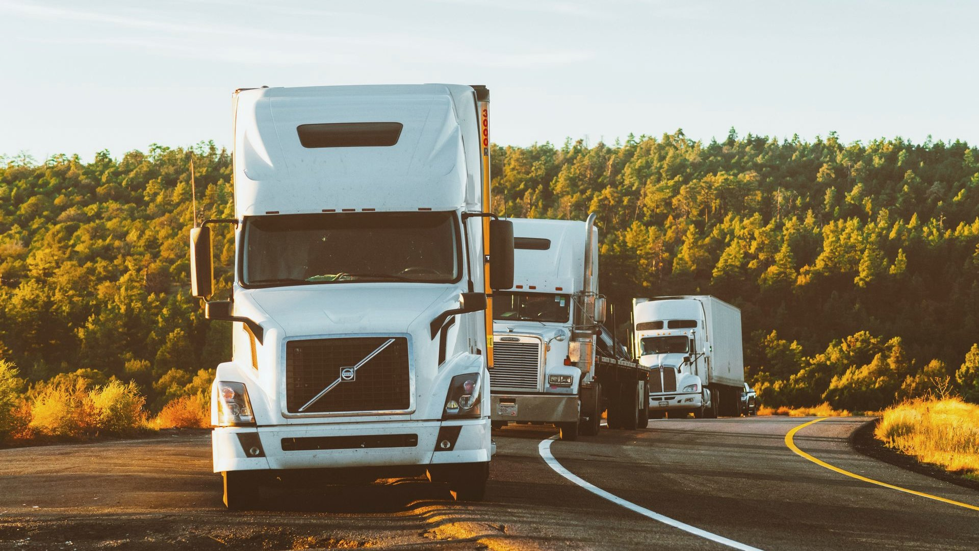 Semi trucks on an Alberta prairie highway under a wide sky